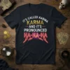 T-shirt featuring the quote "IT'S CALLED KARMA KARMA AND IT'S PRONOUNCED HA-HA-HA" in white, gold, and neon red text with