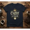 It's Coffee o'clock quote in decorative typography on a navy t-shirt, featuring a coffee cup and alarm clock graphic