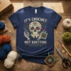 It's Crochet Not Knitting t-shirt with a colorful sugar skull holding crochet hooks and yarn