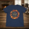 It's Fall y'all text inside an autumn leaf and pumpkin wreath design on a navy blue t-shirt