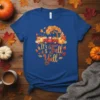 It's Fall Y'all text with red truck, pumpkins, and autumn tree graphic on a blue t-shirt