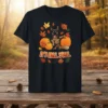 German Shepherd dog surrounded by pumpkins and autumn leaves with "It's Fall Y'all" text on a black t-shirt