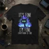 Black t-shirt with white text "IT'S FINE I'M FINE EVERYTHING IS FINE" above a cartoon black cat engulfed in blue