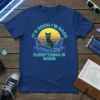 Retro t-shirt design with text "IT'S GOOD I'M GOOD EVERYTHING IS GOOD" featuring a black cat surfing on a surfboard