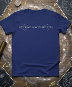 T-shirt featuring the quote "it's good to see me, isn't it?" with celestial graphics, planets, and stars