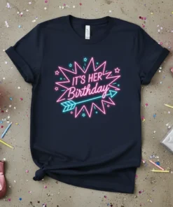 It's Her Birthday text in neon pink and turquoise on a dark navy t-shirt with starburst and arrow graphics