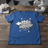 Comic style graphic t-shirt with bold white text "IT'S HIS BIRTHDAY" on a blue shirt, featuring a speech bubble explosion