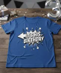 Comic style graphic t-shirt with bold white text "IT'S HIS BIRTHDAY" on a blue shirt, featuring a speech bubble explosion