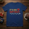 It's His Birthday text with a heart graphic on a navy blue t-shirt, celebrating a special occasion