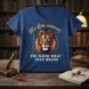 Blue t-shirt with "It's Leo season YOU KNOW WHAT THAT MEANS" text and a stylized lion head graphic with geometric