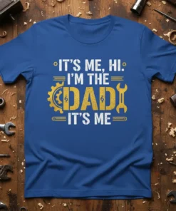 Blue t-shirt with white and yellow text "IT'S ME, HI. I'M THE DAD IT'S ME" featuring gear and wrench graphics