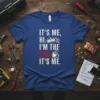 IT'S ME, HI. I'M THE DAD. IT'S ME. text design with crown, gears, and coffee cup graphic on blue t-shirt