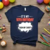 Navy blue t-shirt with white and red neon-style text: "IT'S MY 10TH BIRTHDAY" and a speech bubble saying "SIGN MY