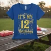 Gold glitter text "IT'S MY 12 Birthday" with a butterfly graphic on a blue t-shirt, designed for a 12th birthday