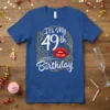 It's My 49th Birthday t-shirt with bold white text and red lips graphic, framed by gold ornate details