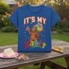 IT'S MY Birthday t-shirt design with a cartoon bear holding a cake and balloons, colorful confetti, and festive text