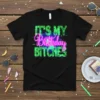 Black t-shirt with neon green and pink text reading "IT'S MY Birthday BITCHES" in a bold, retro font
