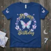 It's my Birthday text with a colorful butterfly and floral wreath on a navy blue t-shirt