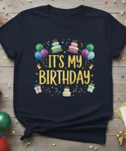 Navy blue t-shirt with gold glitter text "IT'S MY BIRTHDAY" surrounded by balloons, cakes, and gift boxes