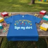 Blue t-shirt with "IT'S MY BIRTHDAY Sign my shirt" text and colorful balloons and lights graphic