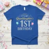 IT'S MY Granddaughter's 1ST BIRTHDAY text with sparkling numbers and balloons on a royal blue t-shirt