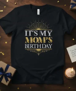 Black t-shirt with "IT'S MY MOM'S BIRTHDAY" text in gold and silver glitter font, art deco design