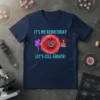 Navy t-shirt with "IT'S MY REBIRTHDAY LET'S CELL-EBATE!" text and a cartoon red cell character holding balloons and a birthday