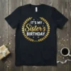 It's My Sister's Birthday text in gold font with a laurel wreath on a black t-shirt