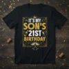 It's My Son's 21st Birthday text with gold glitter, champagne glasses, and a crown graphic on a black t-shirt