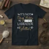It's Not Dog Hair It's Labrador Glitter quote on a black t-shirt, featuring dog-themed graphics