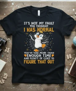 T-shirt with a funny penguin wearing a crown and the quote "It's Not My Fault You Thought I Was Normal"