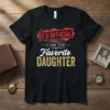 It's Official I Am The Favorite Daughter text design in red and gold on a black t-shirt