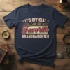 It's Official I Am The Favorite Granddaughter text design on a navy blue t-shirt with retro styling
