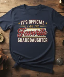 It's Official I Am The Favorite Granddaughter text design on a navy blue t-shirt with retro styling
