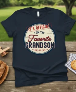 Navy blue t-shirt with "IT'S OFFICIAL I AM THE Favorite GRANDSON" text in a circular vintage design, perfect for favorite