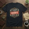 It's Official I Am The Favorite Son-In-Law quote on a black t-shirt with red and gold vintage-style emblem
