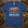 IT'S OFFICIAL I AM THE Favorite SON-IN-LAW text design on a blue t-shirt with red and gold accents