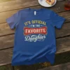 Blue t-shirt with yellow and red text stating "It's Official I'm The Favorite Daughter" in a vintage style