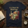 It's Past My Bedtime quote on a navy t-shirt with a sleeping bear in pajamas sitting in a chair