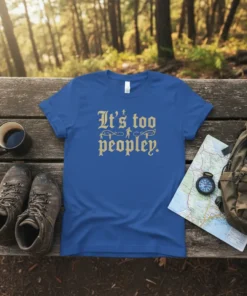 T-shirt with "It's too peopley." text and small figures walking on ropes, on a blue shirt