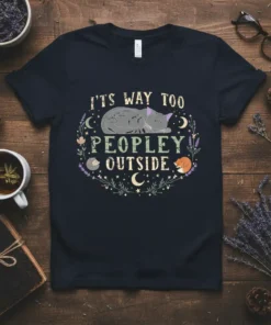 T-shirt with the text "IT'S WAY TOO PEOPLEY OUTSIDE" and a sleeping grey cat graphic, surrounded by floral elements and