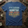 T-shirt with the quote "IT'S WEIRD BEING THE SAME AGE AS OLD PEOPLE" in vintage-style typography