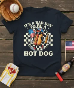 T-shirt design with text "IT'S A BAD DAY TO BE A HOT DOG" featuring a cartoon hot dog holding an