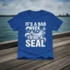 Funny "It's A Bad Week To Be A Seal" quote on a blue t-shirt with a cartoon seal graphic and