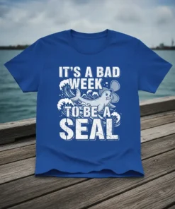 Funny "It's A Bad Week To Be A Seal" quote on a blue t-shirt with a cartoon seal graphic and