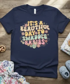 Retro-style text "It's a Beautiful Day to Swaddle Babies" with a graphic of a swaddled baby and flowers on a