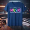 Blue t-shirt with "it's a good day to make MUSIC" in colorful, bold letters and a treble clef graphic