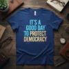 T-shirt with the text "IT'S A GOOD DAY TO PROTECT DEMOCRACY" in bold, colorful font with digital circuit graphics