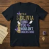 IT'S A OLIVIA THING YOU WOULDN'T UNDERSTAND text with a decorative guitar and purple butterflies on a dark t-shirt