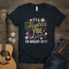 Black t-shirt with "It's a Taylor Vibe You Wouldn't Get It" text in gold and white, surrounded by musical notes